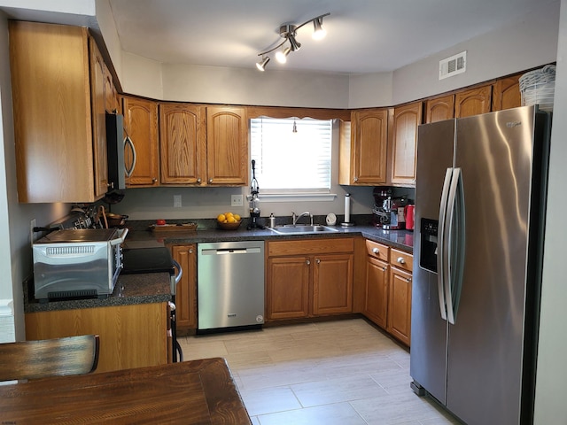 709 E Cooper Ferry Ct Unit 709, Galloway Township, NJ 08205 - kitchen featuring appliances with stainless steel finishes, a sink, brown cabinets, and dark countertops