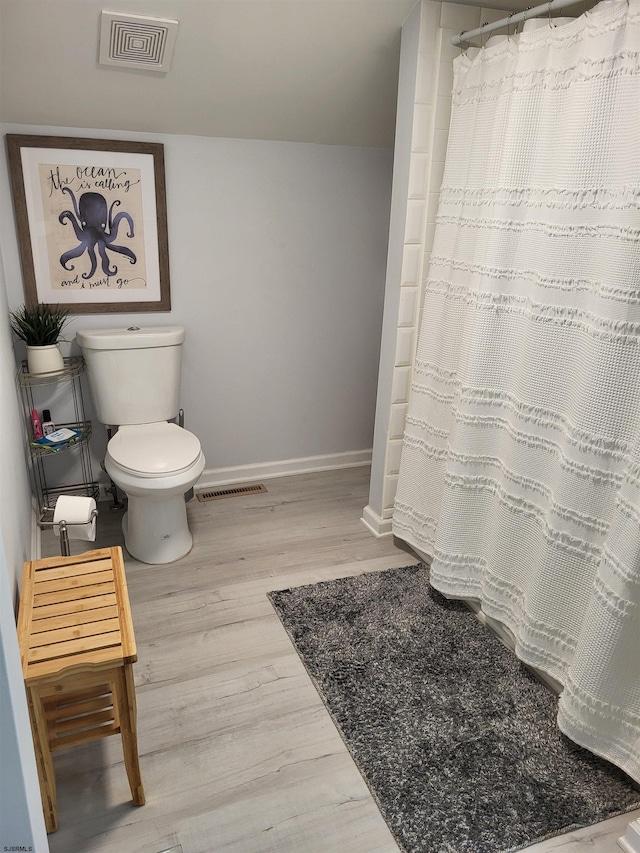 709 E Cooper Ferry Ct Unit 709, Galloway Township, NJ 08205 - bathroom with toilet, wood finished floors, baseboards, and a shower with shower curtain