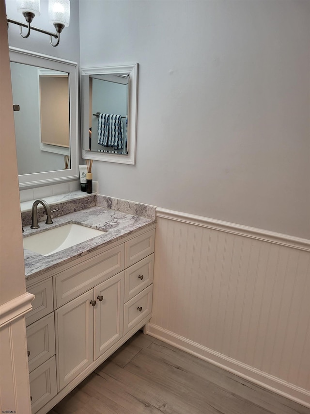 709 E Cooper Ferry Ct Unit 709, Galloway Township, NJ 08205 - bathroom featuring wainscoting, wood finished floors, vanity, and a chandelier
