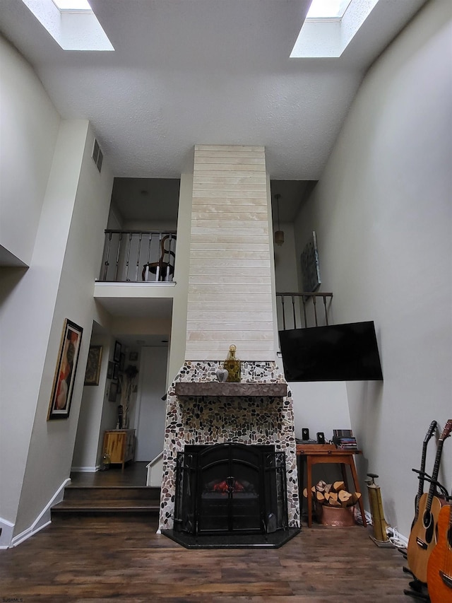 709 E Cooper Ferry Ct Unit 709, Galloway Township, NJ 08205 - living area with a skylight, wood finished floors, baseboards, and a tiled fireplace