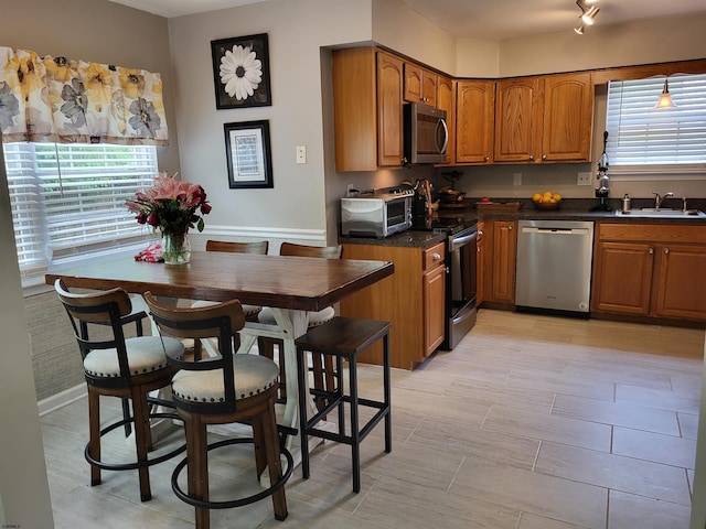 709 E Cooper Ferry Ct Unit 709, Galloway Township, NJ 08205 - kitchen with stainless steel appliances, a sink, brown cabinets, and dark countertops