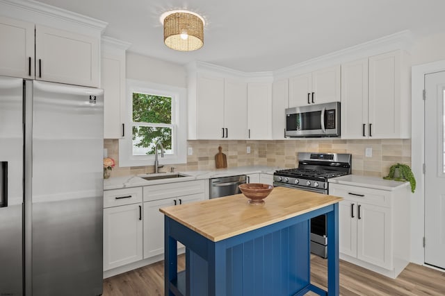 9 Rutgers Rd, Somers Point, NJ 08244 - kitchen featuring appliances with stainless steel finishes, wood counters, a sink, light wood-type flooring, and white cabinetry