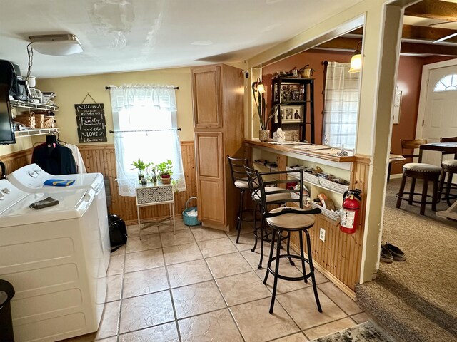 311 N 7th St, Millville, NJ 08332 - kitchen featuring washing machine and dryer, a wainscoted wall, healthy amount of natural light, brown cabinets, and light tile patterned floors