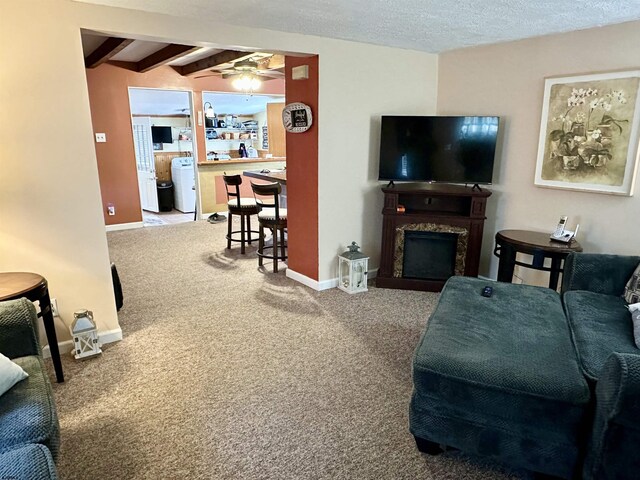 311 N 7th St, Millville, NJ 08332 - carpeted living area with ceiling fan, a fireplace, beam ceiling, baseboards, and washer / dryer
