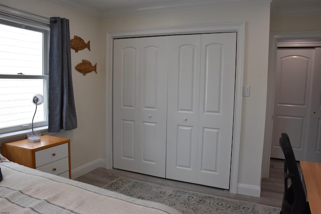 305 Battersea Rd Unit 2, Ocean City, NJ 08226 - bedroom featuring wood finished floors, a closet, baseboards, ornamental molding, and multiple windows