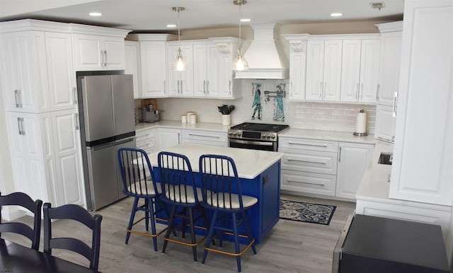 305 Battersea Rd Unit 2, Ocean City, NJ 08226 - kitchen with stainless steel appliances, custom exhaust hood, white cabinetry, light wood-style flooring, and recessed lighting