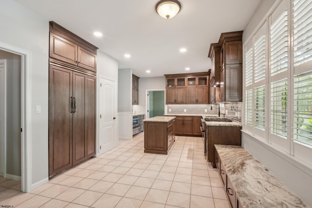 515 Bella Ct, Galloway Township, NJ 08205 - kitchen with backsplash, light tile patterned floors, recessed lighting, glass insert cabinets, and a center island