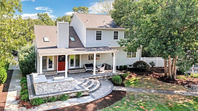 515 Bella Ct, Galloway Township, NJ 08205 - rear view of house featuring a shingled roof, a chimney, and covered porch