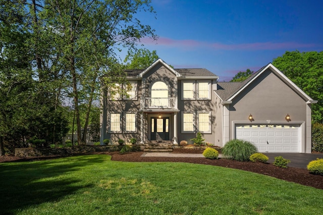 515 Bella Ct, Galloway Township, NJ 08205 - view of front of house featuring asphalt driveway, a lawn, an attached garage, and stucco siding
