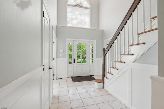 515 Bella Ct, Galloway Township, NJ 08205 - entrance foyer with a towering ceiling, wainscoting, stairway, light tile patterned floors, and a decorative wall