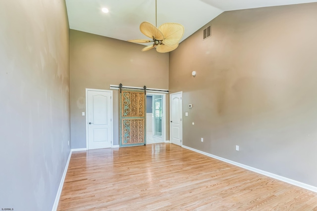 515 Bella Ct, Galloway Township, NJ 08205 - unfurnished room featuring high vaulted ceiling, light wood-type flooring, a barn door, baseboards, and a ceiling fan