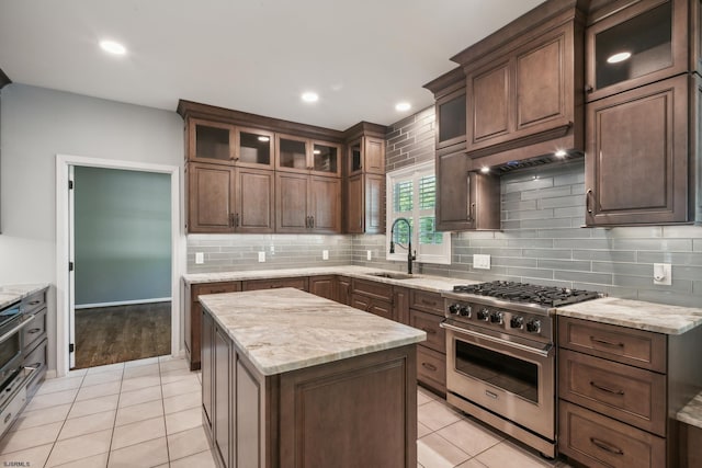 515 Bella Ct, Galloway Township, NJ 08205 - kitchen with high end range, a sink, backsplash, light stone counters, and light tile patterned floors