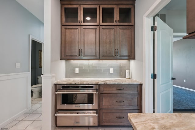 515 Bella Ct, Galloway Township, NJ 08205 - kitchen with stainless steel oven, a warming drawer, backsplash, and glass insert cabinets