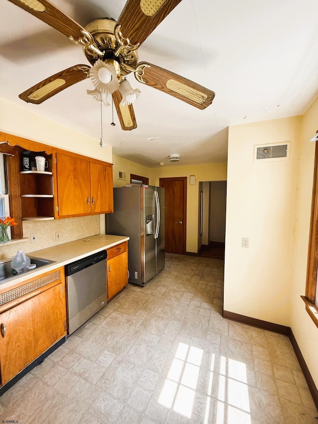 4 E Finley Rd, Upper Deerfield Township, NJ 08302 - kitchen featuring stainless steel appliances, light countertops, baseboards, ceiling fan, and decorative backsplash