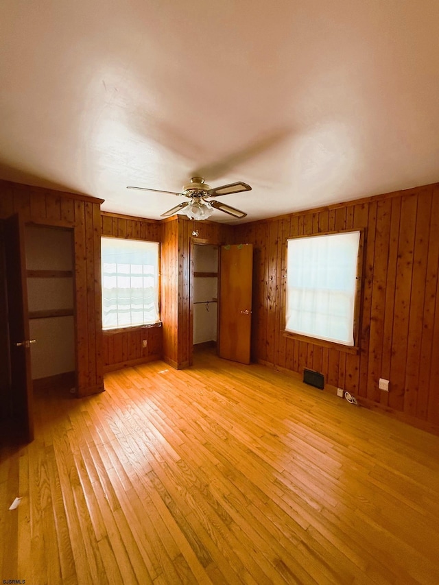 4 E Finley Rd, Upper Deerfield Township, NJ 08302 - unfurnished bedroom with light wood-style floors, wood walls, and ceiling fan