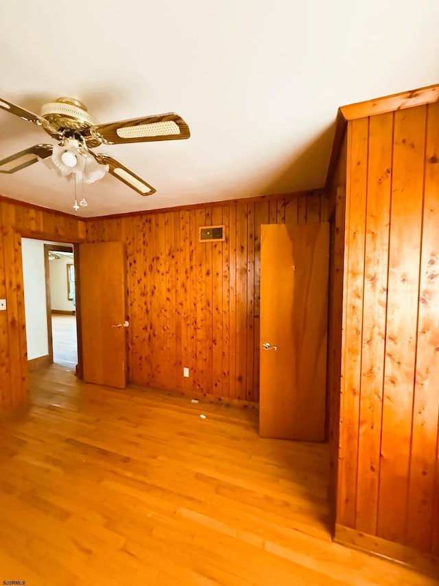 4 E Finley Rd, Upper Deerfield Township, NJ 08302 - spare room featuring wood finished floors, wood walls, and a ceiling fan
