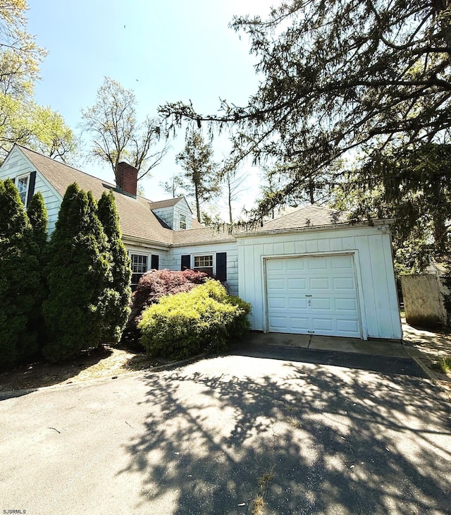 4 E Finley Rd, Upper Deerfield Township, NJ 08302 - view of front of house featuring driveway, a garage, and a chimney