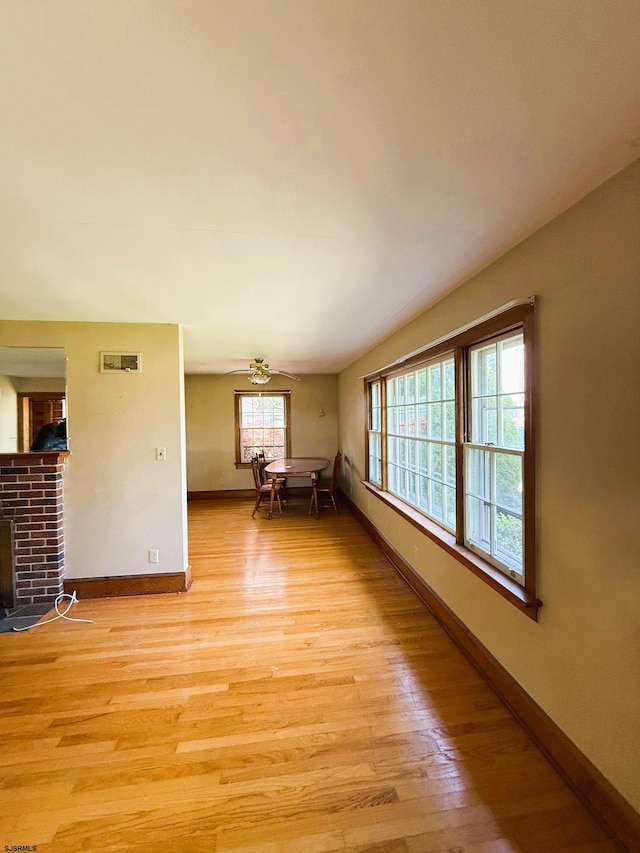 4 E Finley Rd, Upper Deerfield Township, NJ 08302 - spare room featuring light wood finished floors, baseboards, and a brick fireplace