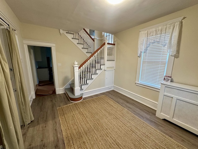 220 Seaside Ave, Atlantic City, NJ 08401 - foyer entrance with dark wood-type flooring, stairs, baseboards, and radiator