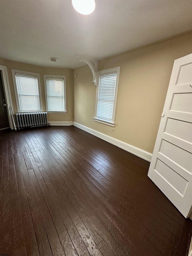 220 Seaside Ave, Atlantic City, NJ 08401 - spare room with radiator heating unit, dark wood-type flooring, and baseboards