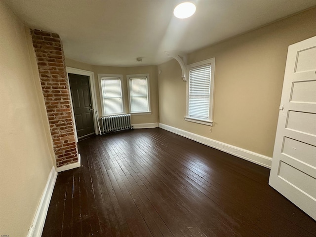 220 Seaside Ave, Atlantic City, NJ 08401 - empty room with radiator, dark wood-style flooring, and baseboards