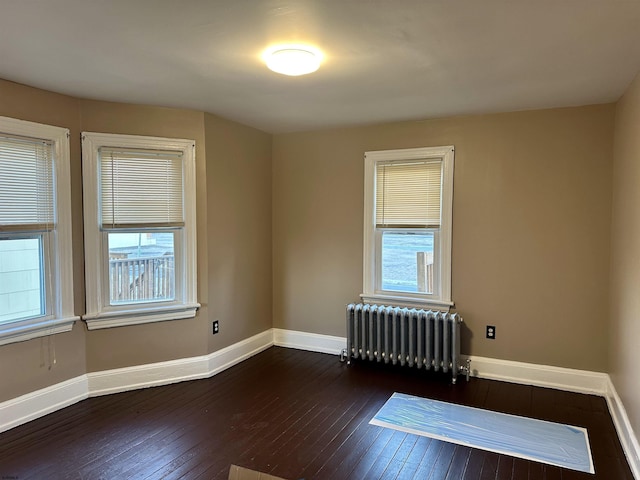 220 Seaside Ave, Atlantic City, NJ 08401 - spare room with radiator heating unit, plenty of natural light, dark wood finished floors, and baseboards