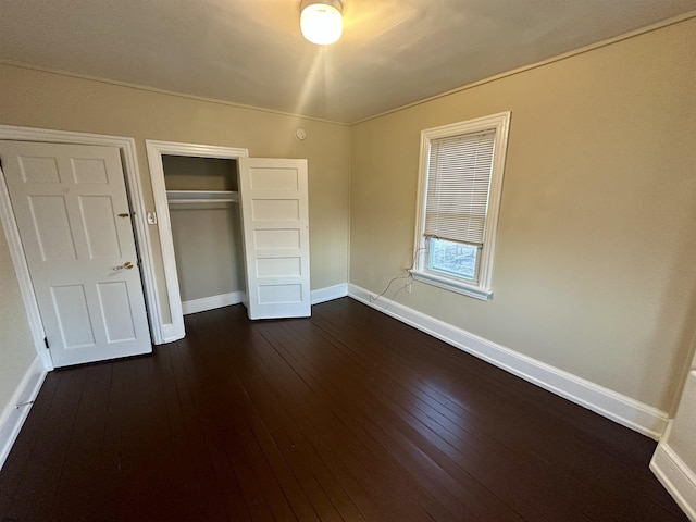 220 Seaside Ave, Atlantic City, NJ 08401 - unfurnished bedroom with baseboards, a closet, and dark wood-type flooring