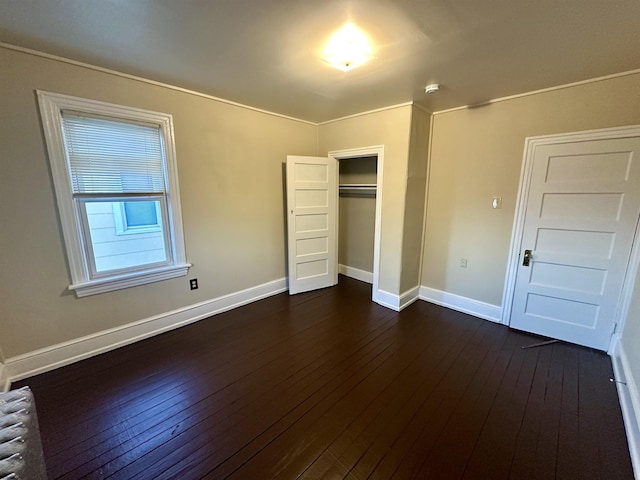 220 Seaside Ave, Atlantic City, NJ 08401 - unfurnished bedroom with dark wood-type flooring, a closet, baseboards, and radiator