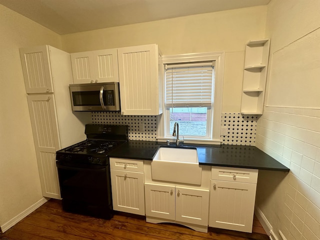 220 Seaside Ave, Atlantic City, NJ 08401 - kitchen with stainless steel microwave, black range with gas cooktop, a sink, dark countertops, and tasteful backsplash
