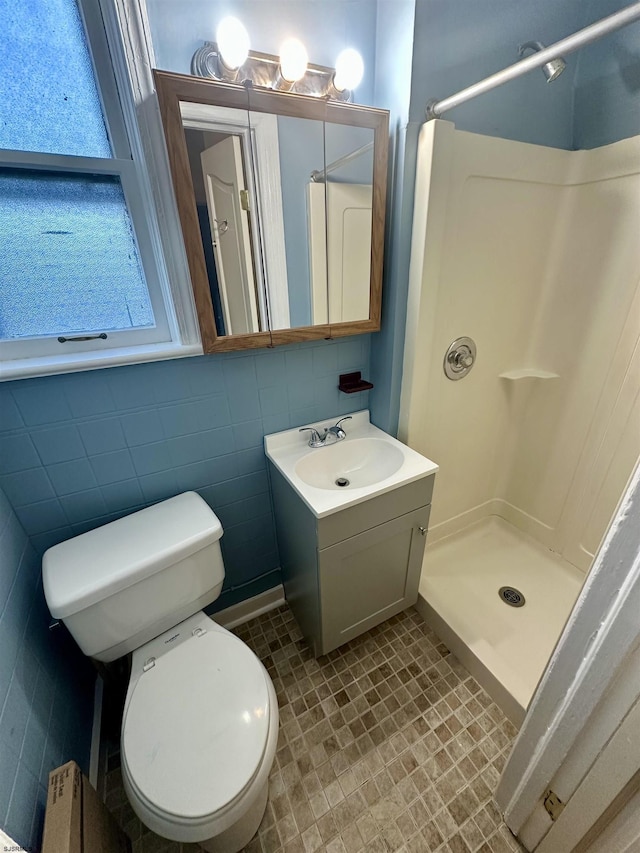 220 Seaside Ave, Atlantic City, NJ 08401 - bathroom with a stall shower, vanity, toilet, and tile walls