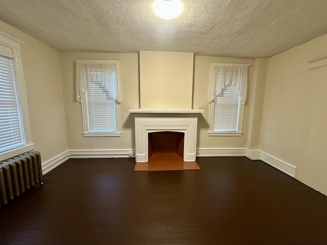 220 Seaside Ave, Atlantic City, NJ 08401 - unfurnished living room featuring radiator, a textured ceiling, wood finished floors, and baseboards