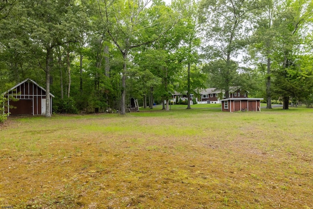 71 Zion Rd, Egg Harbor Township, NJ 08234 - view of grassy yard featuring an outbuilding and view of wooded area