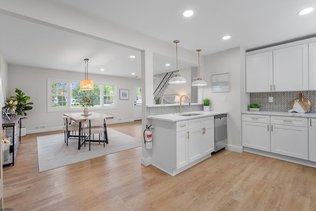 118 Colwick Dr, Somers Point, NJ 08244 - kitchen with a sink, stainless steel dishwasher, tasteful backsplash, a peninsula, and recessed lighting