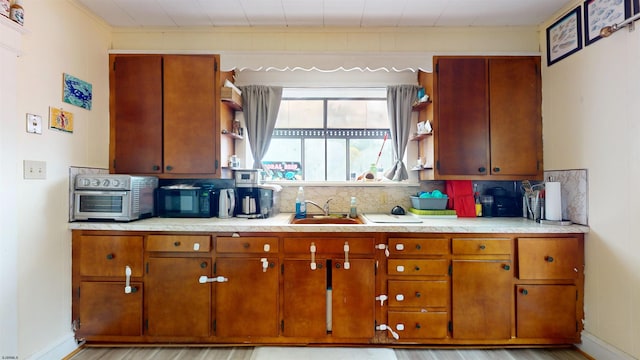27 School St, Absecon, NJ 08201 - kitchen with a sink, tasteful backsplash, light countertops, and black microwave
