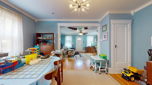 27 School St, Absecon, NJ 08201 - dining room featuring wood finished floors, a chandelier, crown molding, baseboards, and ceiling fan