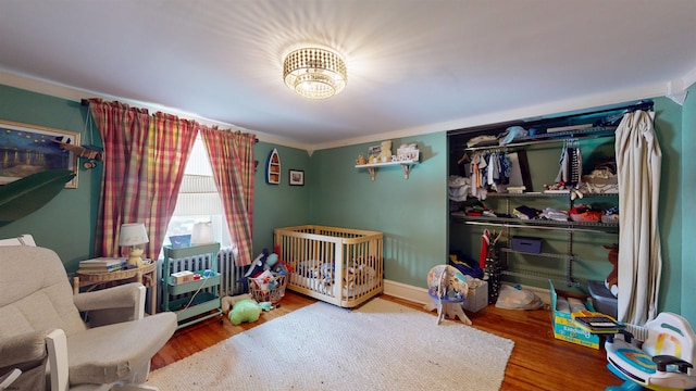 27 School St, Absecon, NJ 08201 - bedroom with wood finished floors and a nursery area