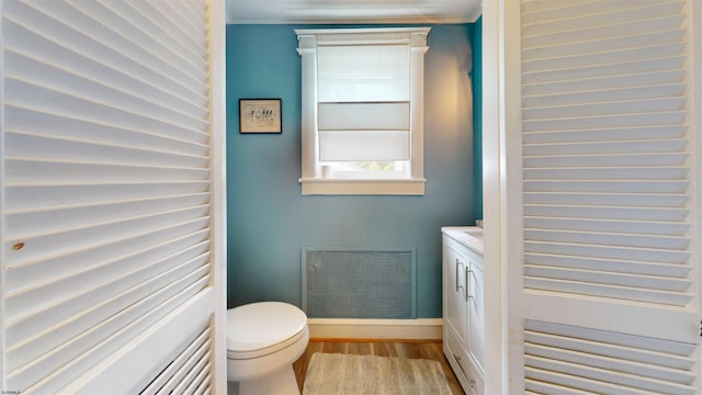 27 School St, Absecon, NJ 08201 - bathroom with wood finished floors, toilet, vanity, and baseboards