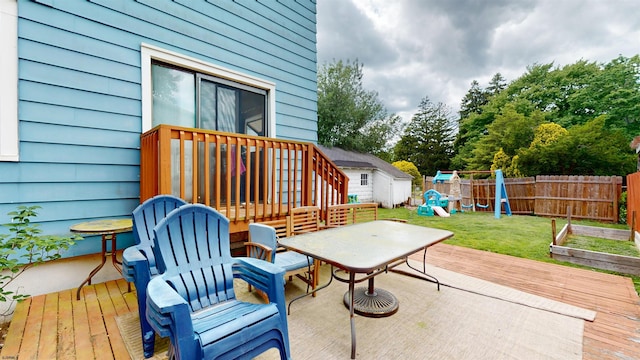 27 School St, Absecon, NJ 08201 - view of patio with a wooden deck, a playground, outdoor dining area, and an outbuilding