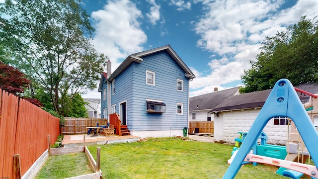 27 School St, Absecon, NJ 08201 - rear view of property with a vegetable garden and a chimney