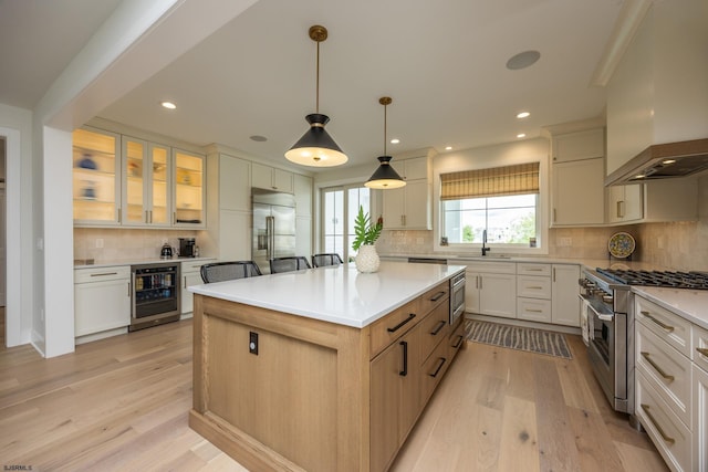3708 Westminster Ln, Ocean City, NJ 08226 - kitchen with beverage cooler, built in appliances, premium range hood, tasteful backsplash, and light wood-style flooring