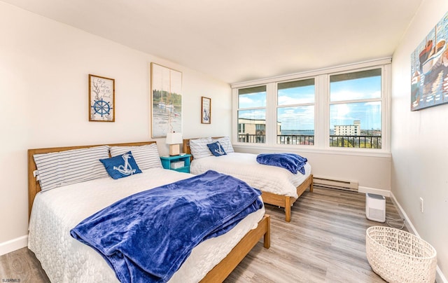 500 Bay Ave Unit 607S, Ocean City, NJ 08226 - bedroom featuring a baseboard heating unit, wood finished floors, and baseboards