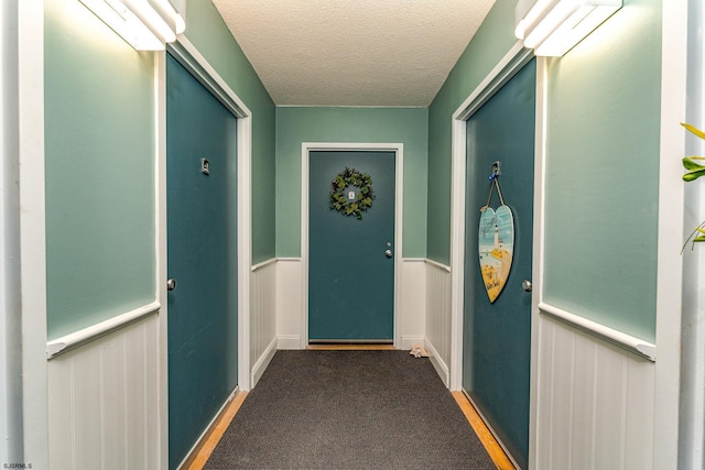 500 Bay Ave Unit 607S, Ocean City, NJ 08226 - doorway with a textured ceiling, wainscoting, and carpet