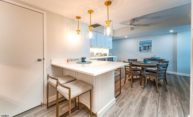 500 Bay Ave Unit 607S, Ocean City, NJ 08226 - kitchen featuring a ceiling fan, light wood-type flooring, a kitchen breakfast bar, light countertops, and recessed lighting