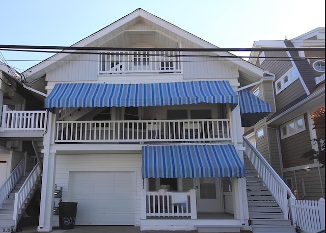 804 Delancey Pl Unit 2, Ocean City, NJ 08203 - view of front of property featuring a balcony, an attached garage, and stairway