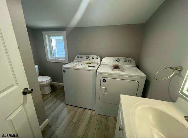 804 Delancey Pl Unit 2, Ocean City, NJ 08203 - washroom featuring washing machine and clothes dryer, light wood-style flooring, and baseboards