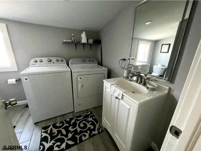 804 Delancey Pl Unit 2, Ocean City, NJ 08203 - washroom with a sink, independent washer and dryer, and wood finished floors
