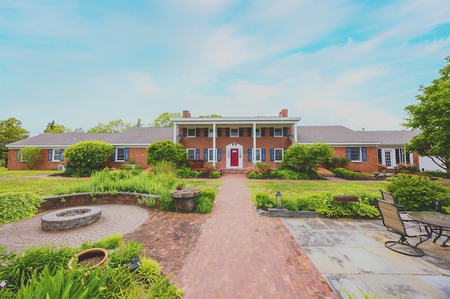 3065 N Rte 9, Ocean View, NJ 08230 - view of front of house featuring a fire pit, brick siding, a chimney, and a front yard