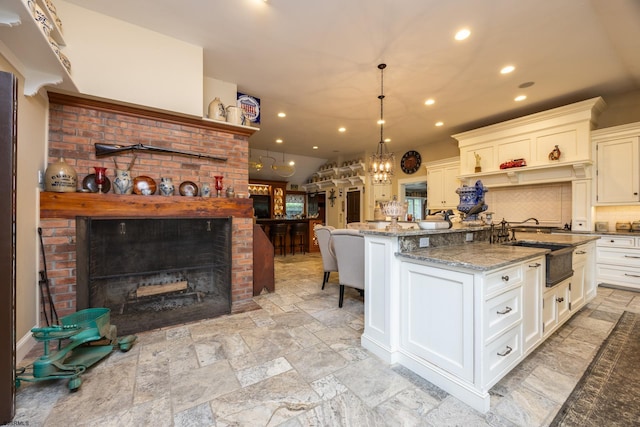 3065 N Rte 9, Ocean View, NJ 08230 - kitchen featuring backsplash, a brick fireplace, light stone counters, stone tile floors, and recessed lighting