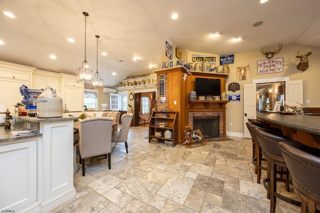 3065 N Rte 9, Ocean View, NJ 08230 - kitchen featuring vaulted ceiling, a breakfast bar, a brick fireplace, stone tile floors, and open floor plan