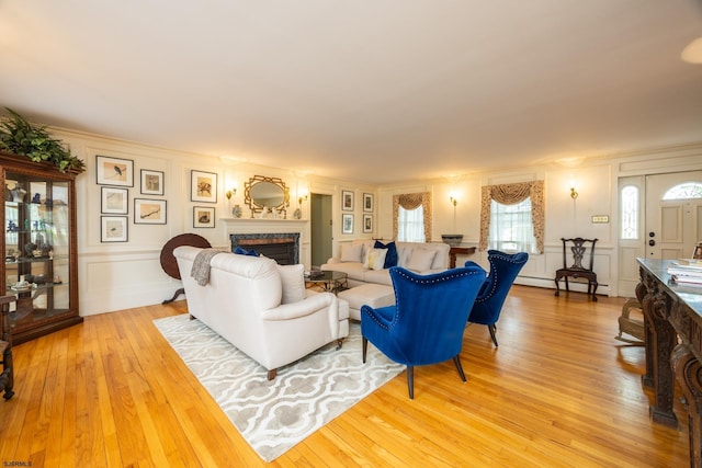 3065 N Rte 9, Ocean View, NJ 08230 - living room with a decorative wall, a baseboard heating unit, a fireplace, light wood-type flooring, and ornamental molding